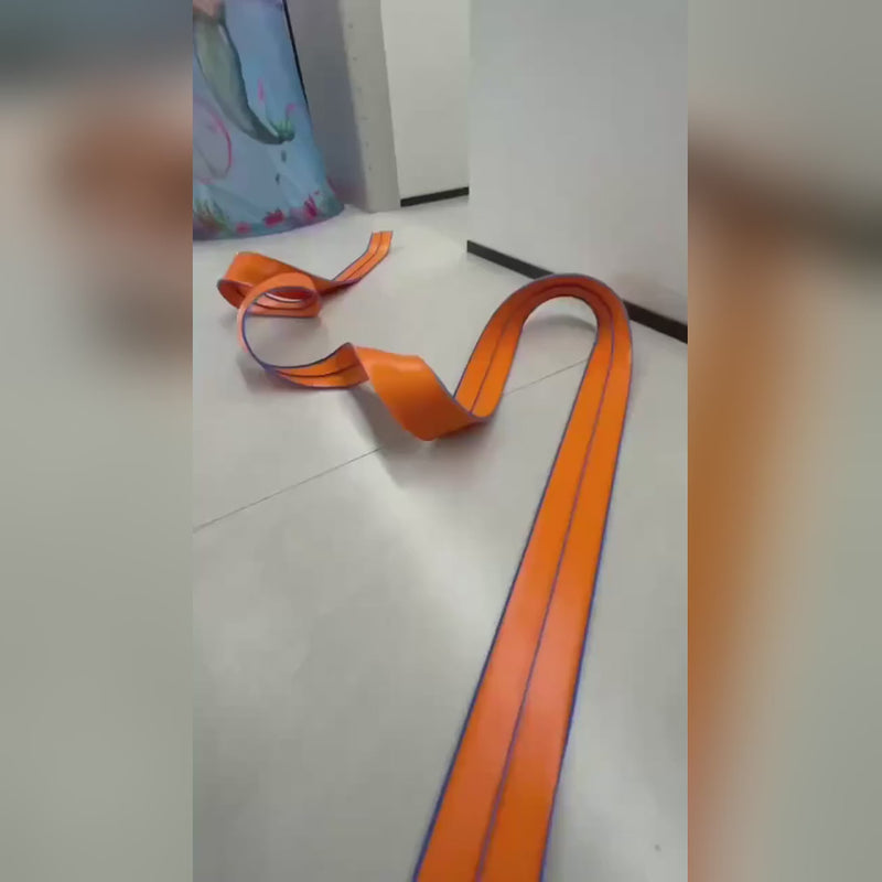 Video cu pista auto flexibilă portocalie așezată în valuri pe podea