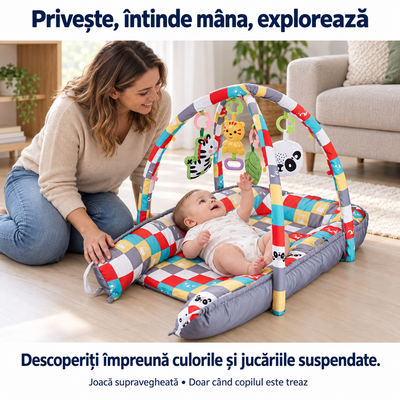 Bebeluș treaz pe salteaua LUDIRO întinzând mâna spre jucăria-frunză, cu părintele alături pentru joacă supravegheată.